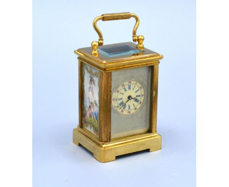 A Miniature Brass Cased Carriage Clock with sevres style panels and silvered dial with lever escapement 6 cms tall 