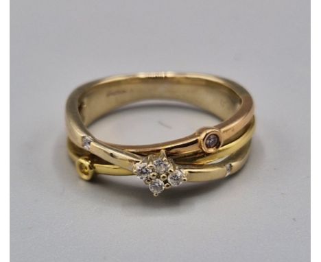 An 18ct gold crossover ring set with four diamonds, 5.1 grams, ring size M 