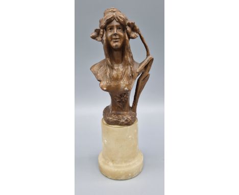 An Art Nouveau patinated bust of a girl with marble socle, 19cms tall 