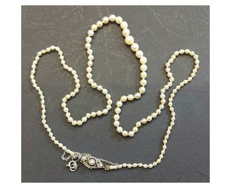 A natural and cultured pearl necklace, the white metal clasp set with diamonds and central pearl, complete with AnchorCert Ge