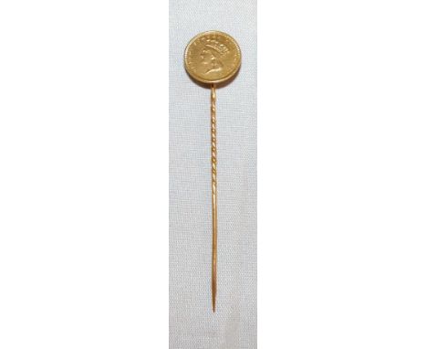 A stick pin set with an 1856 gold dollar