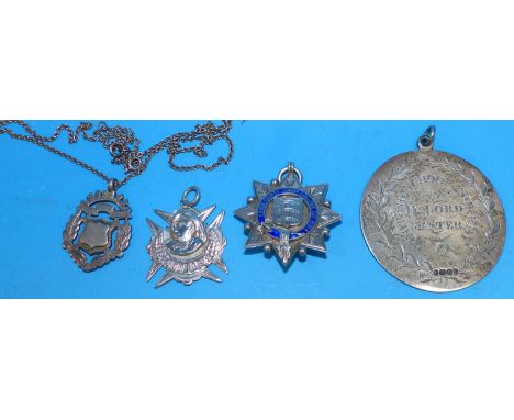 A large hallmarked silver chased medallion, school prize; a silver enamel brooch; 2 silver fobs, 2½ oz.