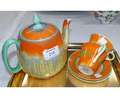 A 1930's Shelley dripware teapot and 2 cups and saucers