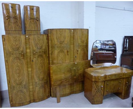 A 1930's figured walnut 6 piece bedroom suite comprising double wardrobe, gent's wardrobe, dressing table, pair of bedside ca