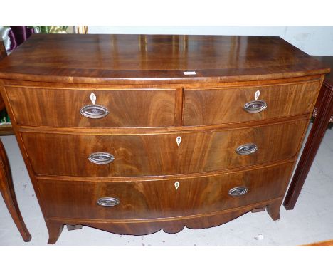 A 19th century mahogany crossbanded bow front chest of 2 long and 2 short drawers, with brass drop handles on oval back plate