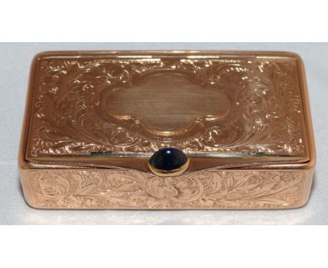 A yellow metal chased rectangular snuff box, the clasp mounted with cabochon cut oval sapphire, stamped '585'