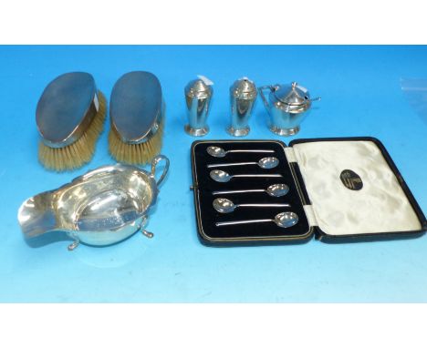 A silver sauce boat, Sheffield 1934; an Art Deco silver cruet set, Birmingham 1933; a set of coffee spoons; a pair of silver 