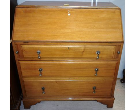 An Edwardian mahogany fall front bureau with 3 drawers, tapering drop handles and bracket feet.