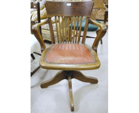 A 1920's sprung office swivel arm chair