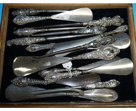 A collection of shoe horns and button hooks