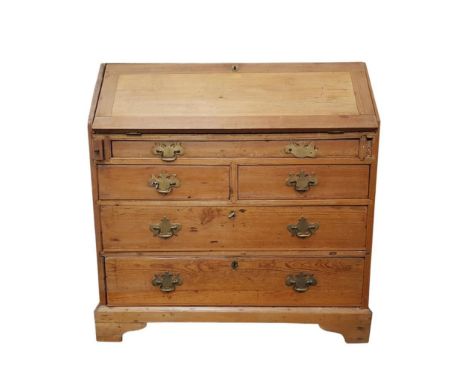 of rectangular form, the slope drop front bureau opening to reveal a fitted interior above a shallow frieze drawer resting on
