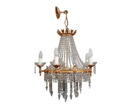 the gilt metal and cut glass chandelier held on a single central support with multiple sconces, all adorned with runs of drop