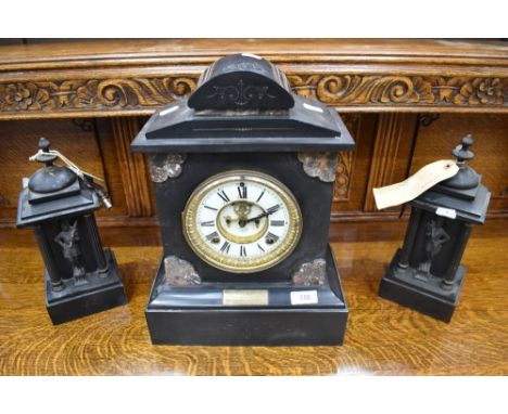 A Victorian black slate and varigated marble mantel clock, the circular dial with Roman hours and Brocot escapement, applied 