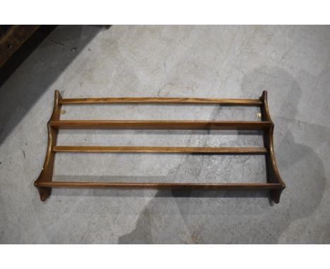 A mid/dark stained Ercol wall shelf, width approx. 96cm