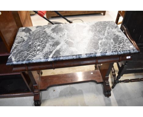 A Victorian console table on carved feet with Mahogany frame under drawers and faux marble painted top.