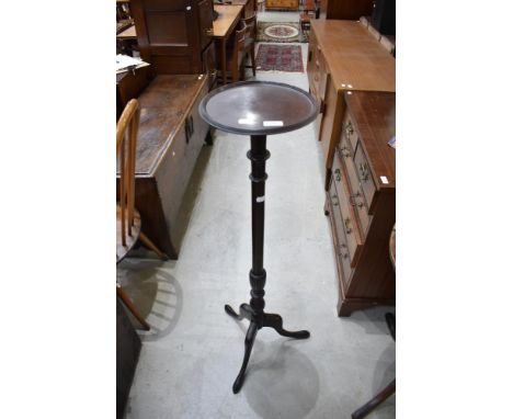 A Victorian torchere stand on a Mahogany frame with tripod base.