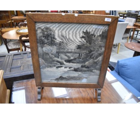A mid 20th century oak firescreen, having printed material river-scene panel