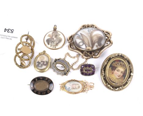 A collection of eight 19th century and later mourning brooches. Including a gold-plated shaped-oval example with a tubular fr