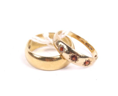 Two gold rings. Comprising; an 18ct gold broad wedding band, hallmarks for London 1989, size leading edge I, 5g; and a 9ct go