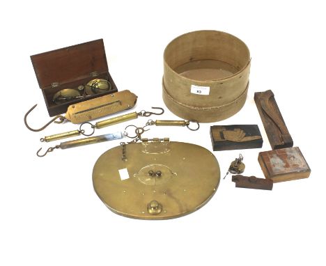 A group of assorted metal and wooden vintage collectables. Including brass spring and balance scales, letter printing blocks,