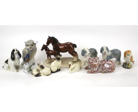 A collection of assorted ceramic animal figures. Including Beswick cats, Nao owl, Sylvac old English sheepdog and Rosenthal k