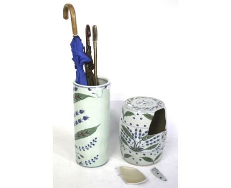 A matching contemporary ceramic garden seat (AF) and an umbrella stand. Painted with leaf and flower decoration. Plus two umb
