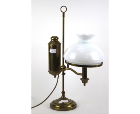 A brass oil lamp style electric table light. With white glass shade. H55cm