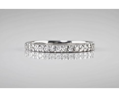 An 18ct white gold and diamond half eternity band, with pavé diamonds totalling approximately 0.33ct. Ring size P. 