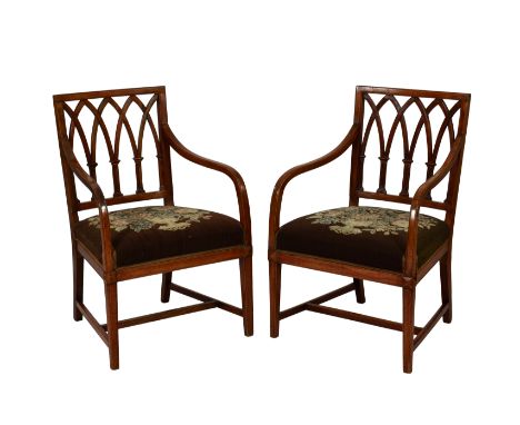 A pair of George III mahogany ebow chairs, the square backs with interlaced arches, over downswept arms and stuff over tapest