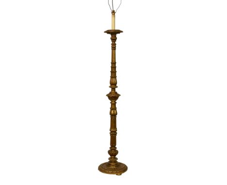 A Louis XIII style giltwood standard lamp, early 20th century, the turned column with foliate and fluted decoration, on a cir