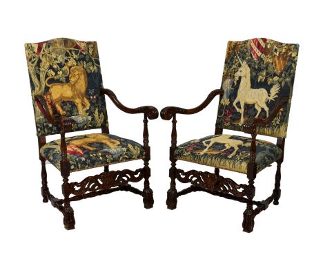 A pair of Carolean style carved and stained beech armchairs, 20th century, the serpentine backs and stuff over seats upholste
