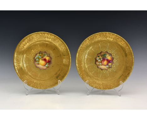 Two Royal Worcester 'Fruit' gilded porcelain cabinet plates, each with indistinct signatures, centrally decorated with fruit,