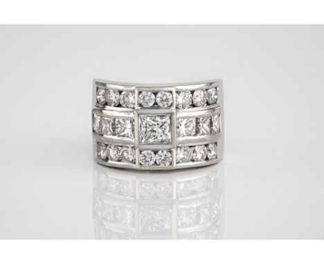 A fine 18ct white gold and diamond ring, set with three rows of princess and brilliant cut diamonds, centred by a 1.01ct prin