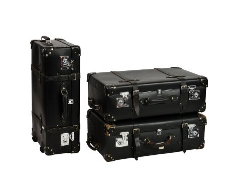 A set of three vintage Globetrotter suitcases, black leather with chrome fittings and two leather exterior straps, side and e