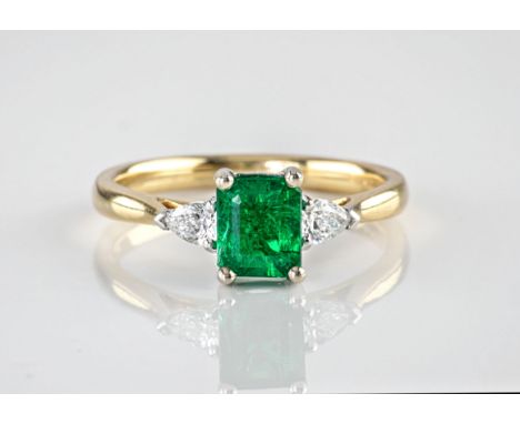 An 18ct yellow gold and 'no oil' emerald ring, the step cut emerald of deep, green colouring and weighing approximately 0.96c