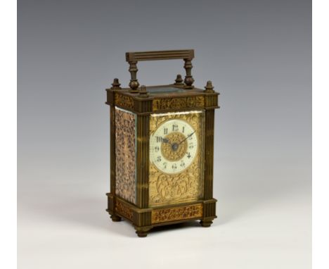 A French gilt brass single train carriage clock, c.1900, the fluted column case with floral and foliate mask and pierced side