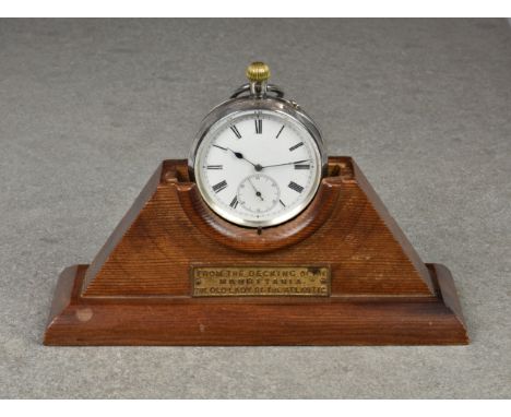 A pocket watch stand made from wood from the decking of the Mauretania, with gilt plaque, 2 3/8in. (6cm.) high; together with