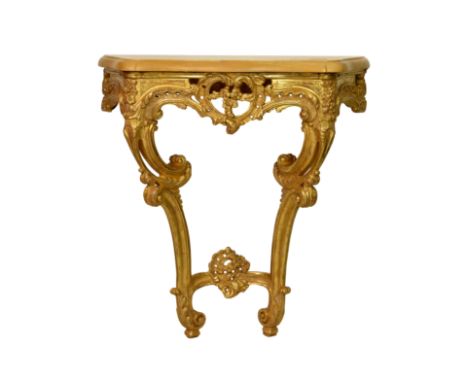 A pair of Louis XV style carved giltwood and marble console tables, 20th century, the ochre marble top over a pierced floral,