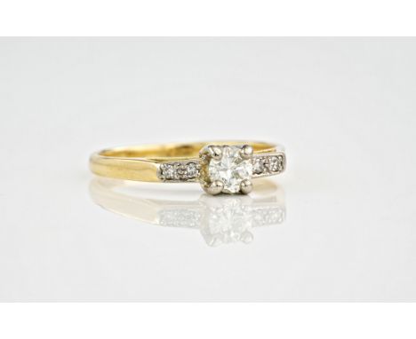 An 18ct yellow gold diamond ring, the central, brilliant cut diamond measuring approximately 0.36ct, with diamond set shoulde