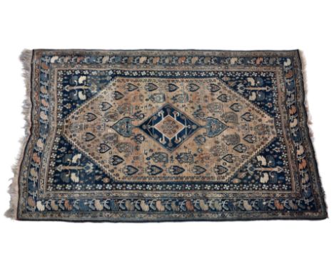 A Bulwadi / Qashqai rug, south west Persia, the faded madder field with floral boteh and Herati motifs, around a dark blue oz