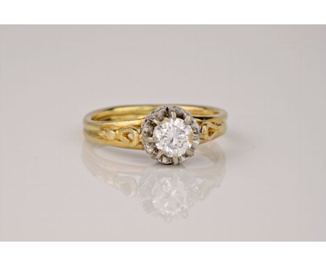 A vintage 18ct yellow gold and diamond solitaire ring, 1930s in design, the central stone held high in an elaborate white gol