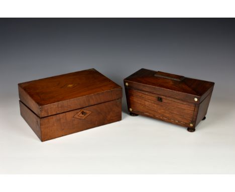 A 19th century mahogany sarcophagus-shaped tea caddy, of typical form, the front with metal string banding and M.O.P discs to