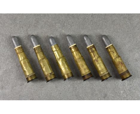 Six .577 Martini-Henry lack powder centrefire rifle cartridges, each stamped with letters K & I with broad arrow. (spent) * N