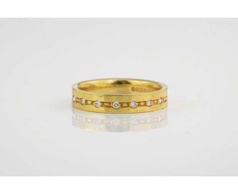 An 18ct yellow gold and diamond ring, half of the band studded with 7 diamonds totalling 0.25ct. Ring size M. 