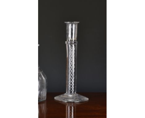 An antique airtwist glass candlestick, probably 19th century, the cylindrical nozzle above a plain collar, on a triple mercur
