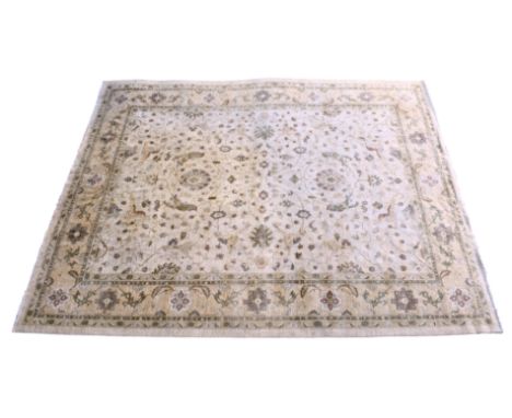 A large Indian Oushak style wool carpet, late 20th century, the cream ground withoverall floral and scrolling foliate decorat