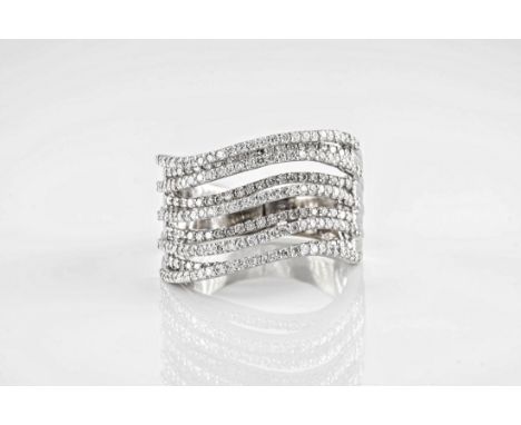 An 18ct white gold and diamond multistrand ring, featuring 9 undulating pavé diamond set bands in a contemporary design. Ring