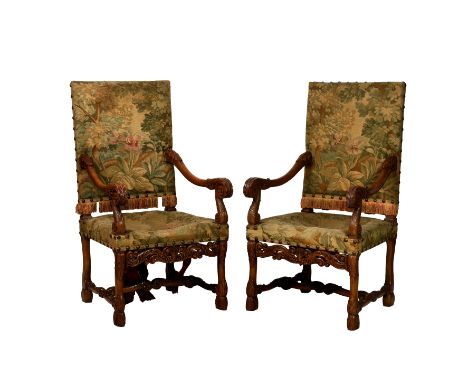 A pair of Victorian carved oak open armchairs in the 17th century style, the upright, rectangular back and seat in original, 