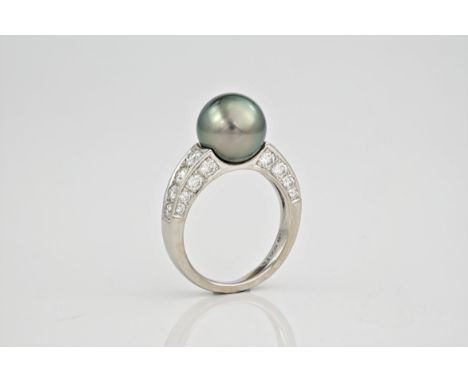 A black Tahitian pearl, diamond and platinum ring., The 10mm Tahitian black pearl set into platinum with 24 very good diamond