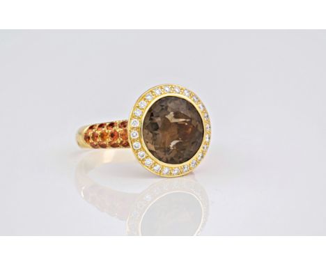 An 18ct yellow gold smoky quartz and topaz dress ring, the brilliant cut smoky quartz surrounded with a brilliant diamond sur